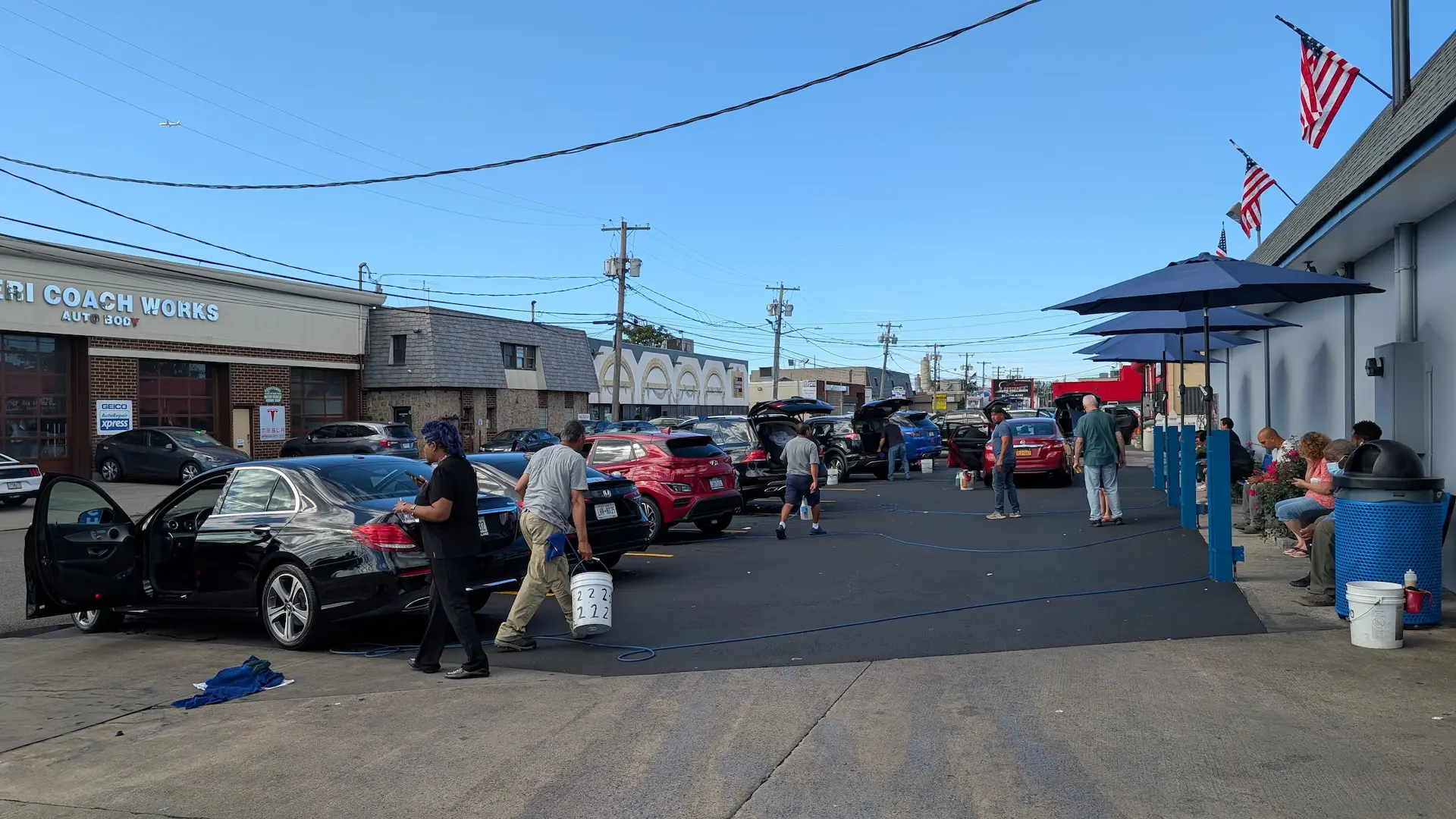 Busy car wash with multiple vehicles being detailed outside Shine Time Car Wash