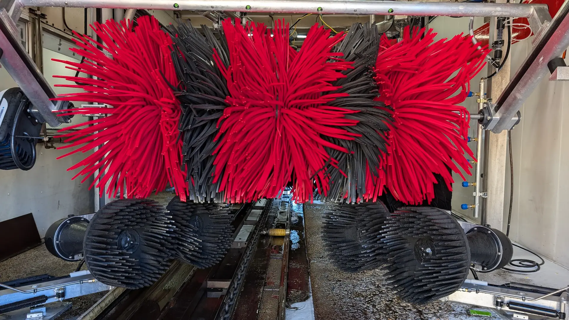 Close-up of new red and black car wash brushes at Shine Time Car Wash